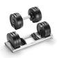 Pair of black adjustable dumbbells with silver handles, one standing alone and one resting on silver base tray, on white back