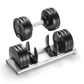 Pair of black adjustable dumbbells with silver handles on matching storage tray, shown on white background