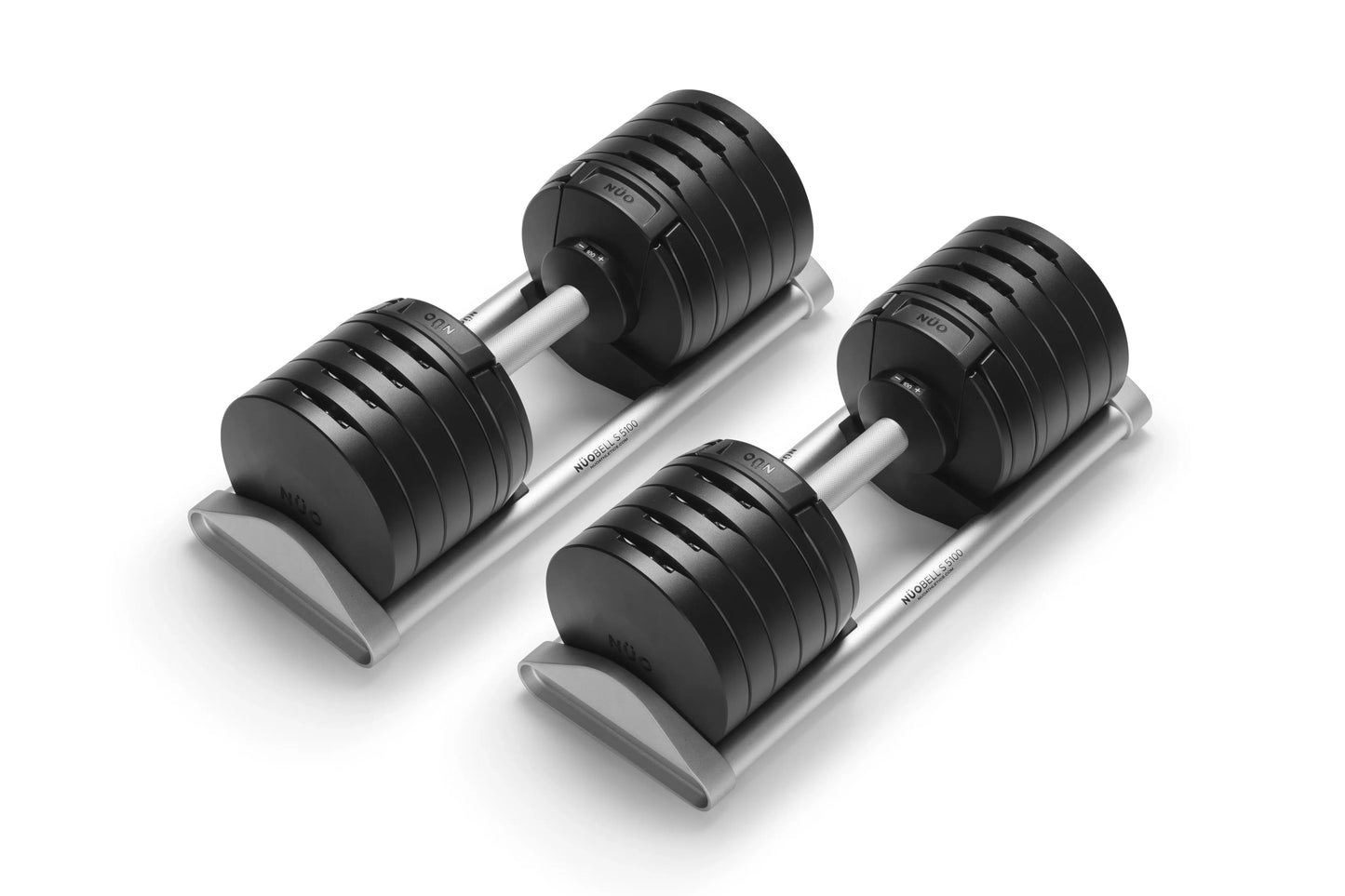 Pair of black adjustable dumbbells with silver handles on gray trapezoidal base, shown on white background