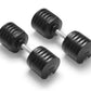 Pair of black adjustable dumbbells with grooved rubber grip plates and metal handles, shown on white background