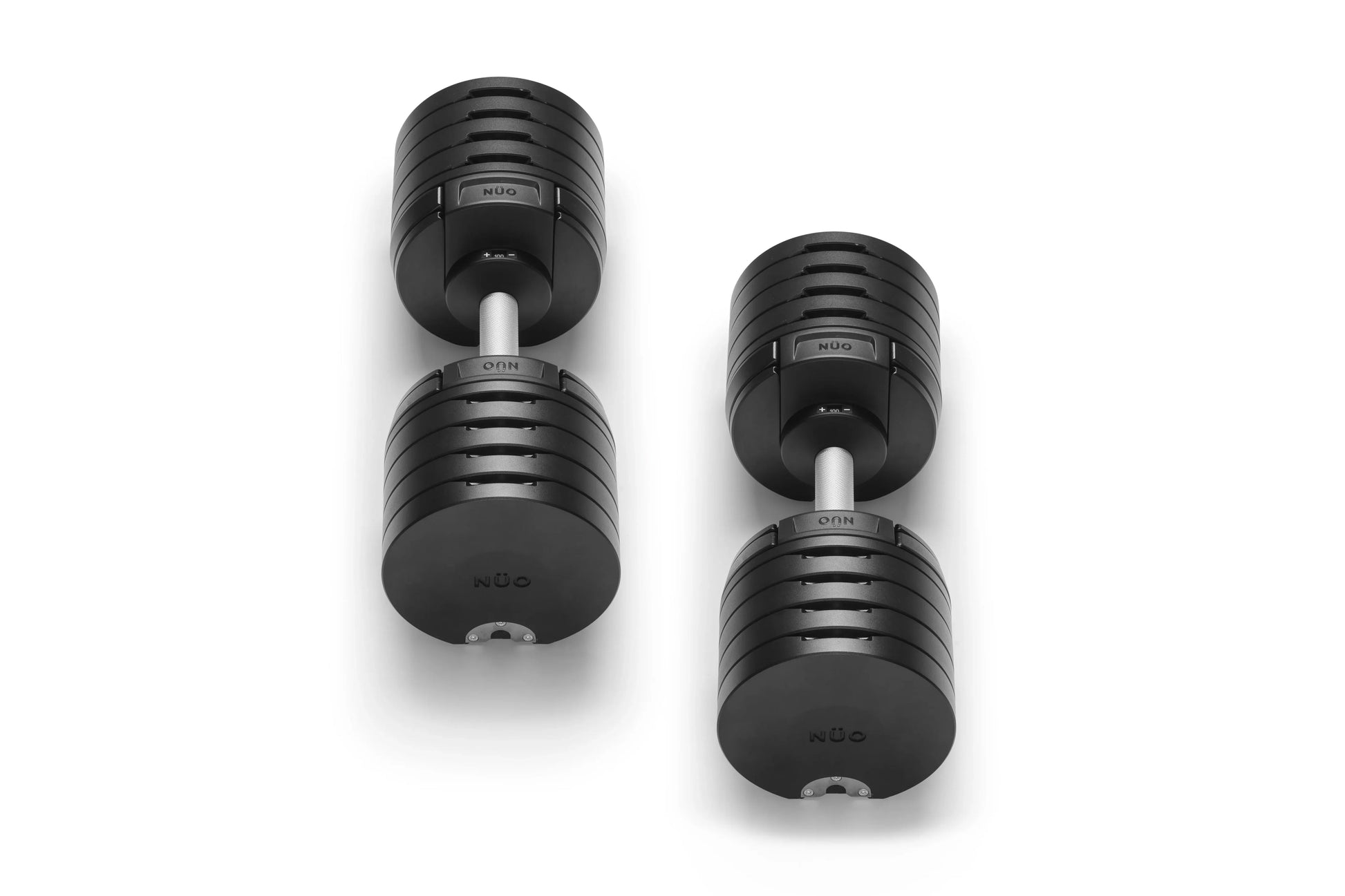 Pair of black adjustable dumbbells with ribbed grip handles and white connectors on white background