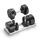 Pair of black adjustable dumbbells with silver handles and weight plates on matching silver tray, displayed on white backgrou