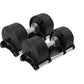 Pair of black adjustable dumbbells with silver handles and weight plates, on white background