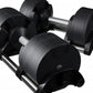 Pair of black adjustable dumbbells with textured rubber coating and metal handles on white background