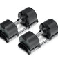 Pair of black adjustable dumbbells with metal handles and weight plates on white background