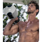 Man holding adjustable ash and black dumbbell outdoors, demonstrating weight training equipment