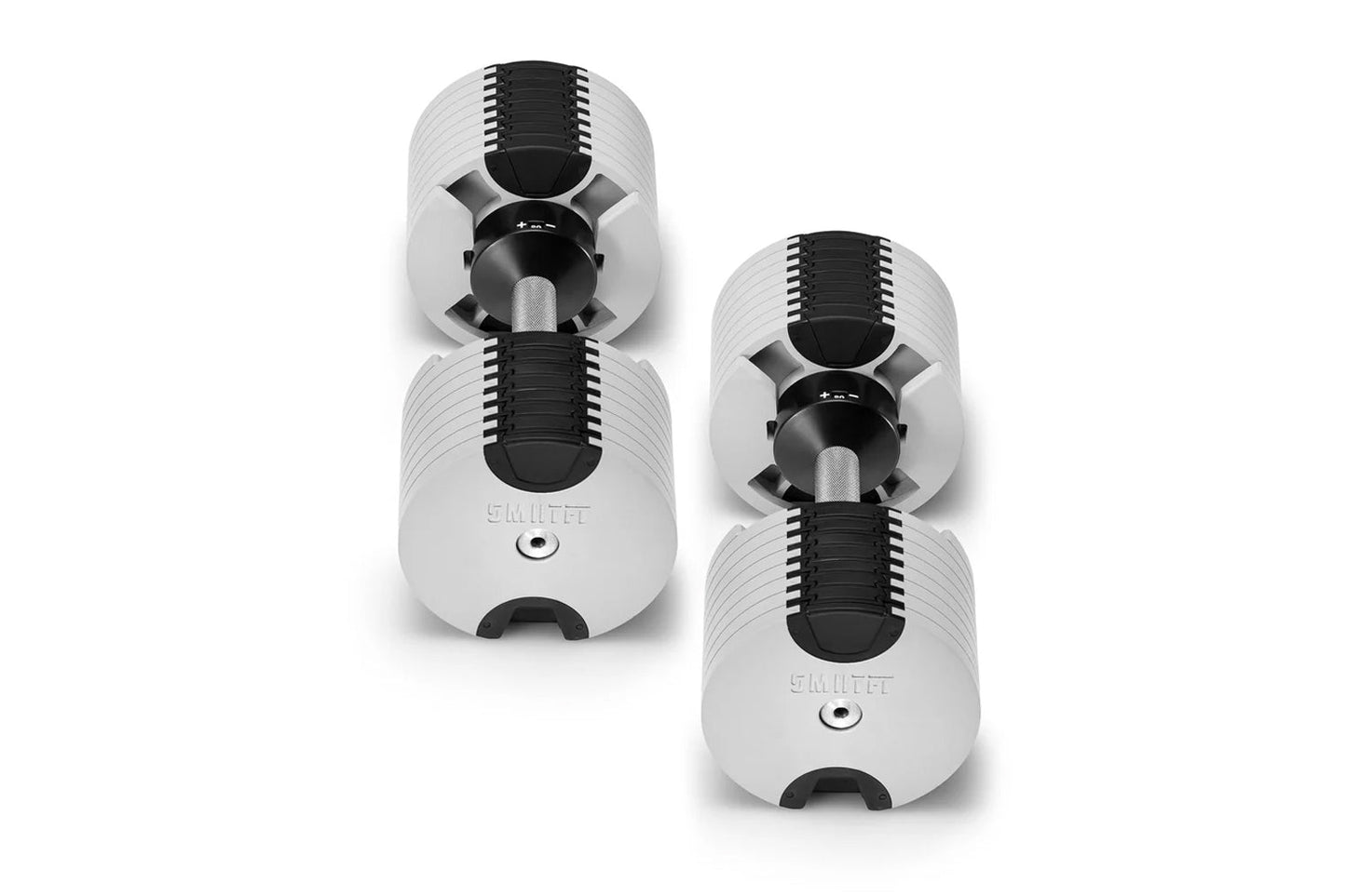Three NÜOBELL adjustable dumbbells in white and black with ribbed weight plates, shown stacked at angles on white background