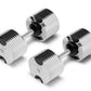 NÜOBELL adjustable dumbbells with white and black grooved plates, silver handles, shown as pair on white background