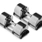 Set of three adjustable dumbbells with white and black weight plates and metallic handles on white background