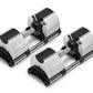 Pair of Nüobell adjustable dumbbells with white and black striped weight plates, gray handles, and black bases on white backg