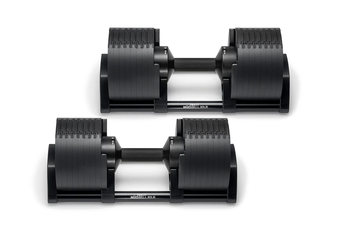Pair of black adjustable dumbbells with vertical ribbed weight plates and gray handles, labeled 80lb, shown on white backgrou
