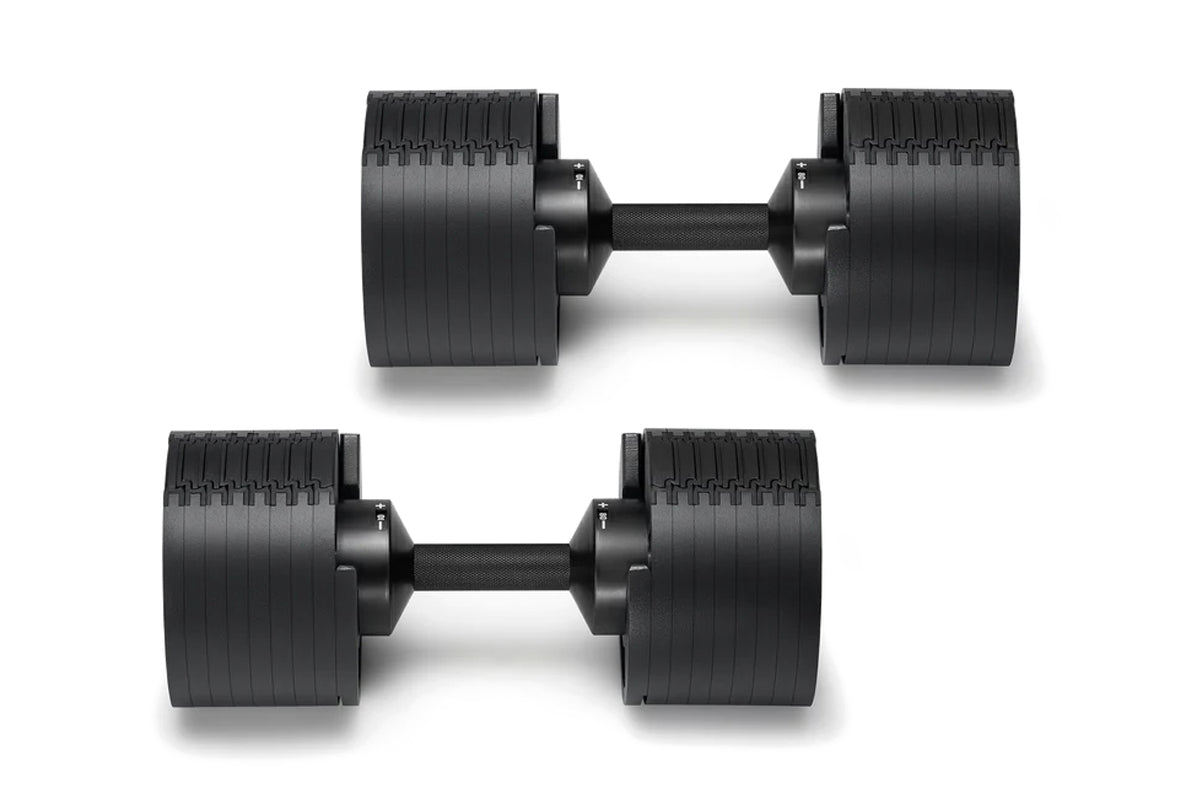 Pair of matte black adjustable dumbbells with ribbed weight plates and black handles on white background