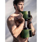 Man holding green and black adjustable dumbbells with weight increments, worn shirtless against white background