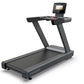 Black and gray Octane OC100 treadmill with 10" touch console display and control panel on white background