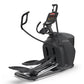 Black elliptical machine with digital console, curved handles, and wide footplate on white background