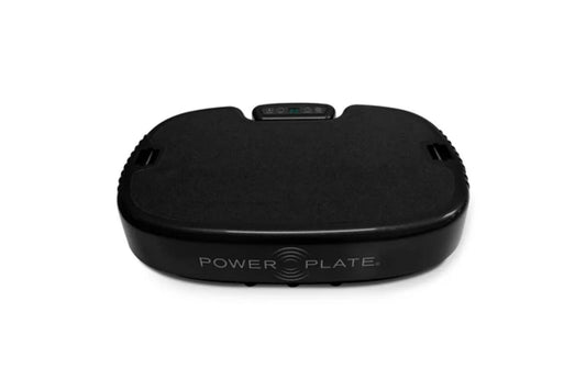 Black Power Plate vibration machine with digital display and curved platform on white background
