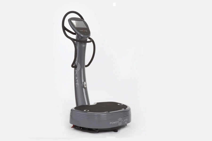 Power Plate My7 vibration plate trainer with gray platform, black upright pole, and handlebar on white background