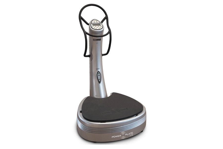 Power Plate Pro5 vibration training machine with silver metal body, black platform, and overhead handlebar on white backgroun