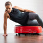 Woman in black tank top and gray leggings performing plank exercise on red Power Plate MOVE vibration trainer