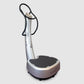 Silver and black vibration platform with curved handrails and textured footplate on white background
