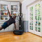 Man in plank position using black Power Plate My5 vibration trainer in bright home gym with white cabinetry and garden doors