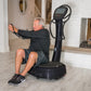 Black Power Plate My7 vibration plate trainer with digital display, man using device in home gym setting