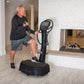 Man exercising on black Power Plate My8 vibration plate trainer with digital display in home gym setting