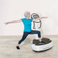 Senior woman in bright blue t-shirt and navy leggings exercising on white Power Plate vibration trainer with arms extended in
