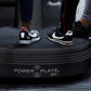 Multiple people wearing athletic sneakers standing on black Power Plate Pro5 vibration training platform