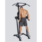 Black power tower with VKR station and pull-up bar, model demonstrating use in gray shorts on white background