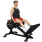 Man wearing black tank top and red shorts using Powertec black leg sled machine with weight plates, white socks, on white bac