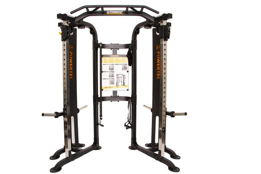 Black and silver dual-sided functional trainer with cable machines, adjustable arms, and instruction placard on white backgro