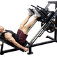 Man using black and silver leg press machine with weight plates, demonstrating seated leg exercise position on white backgrou