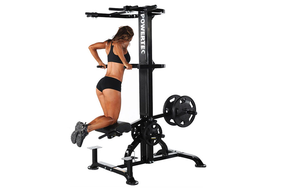 Woman performing chin-up exercise on black Powertec WorkBench LeverGym with weight plates, shown on white background