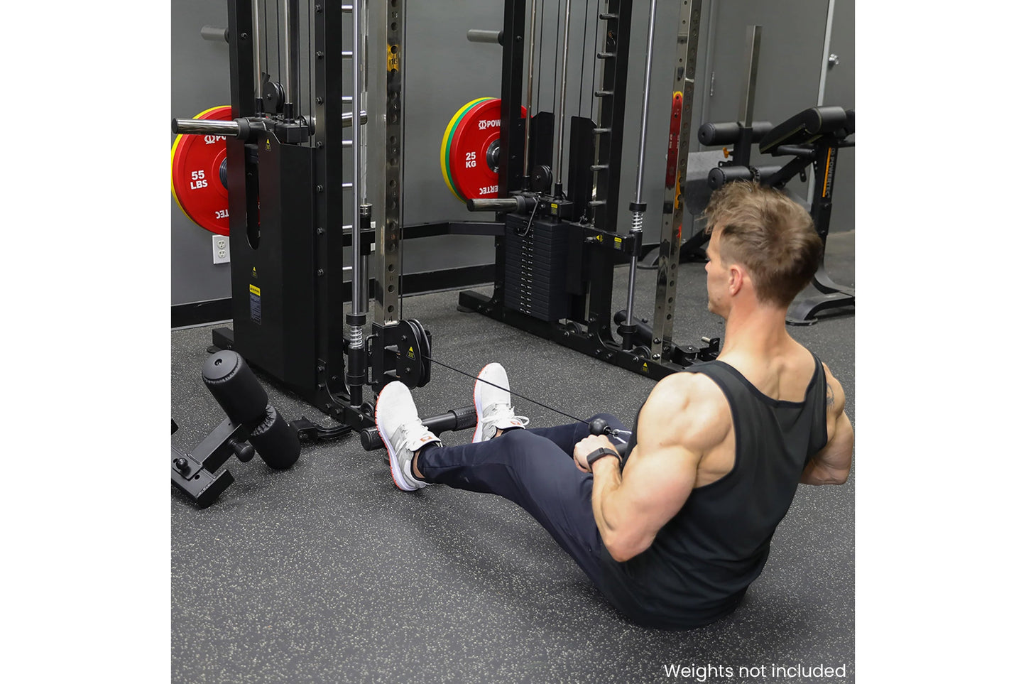 Man using black Smith machine with red weight plates in gym setting, weights not included