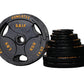 Powertec Grip cast iron Olympic weight plates set in black with orange text markings, including one 45lb plate and stacked pl