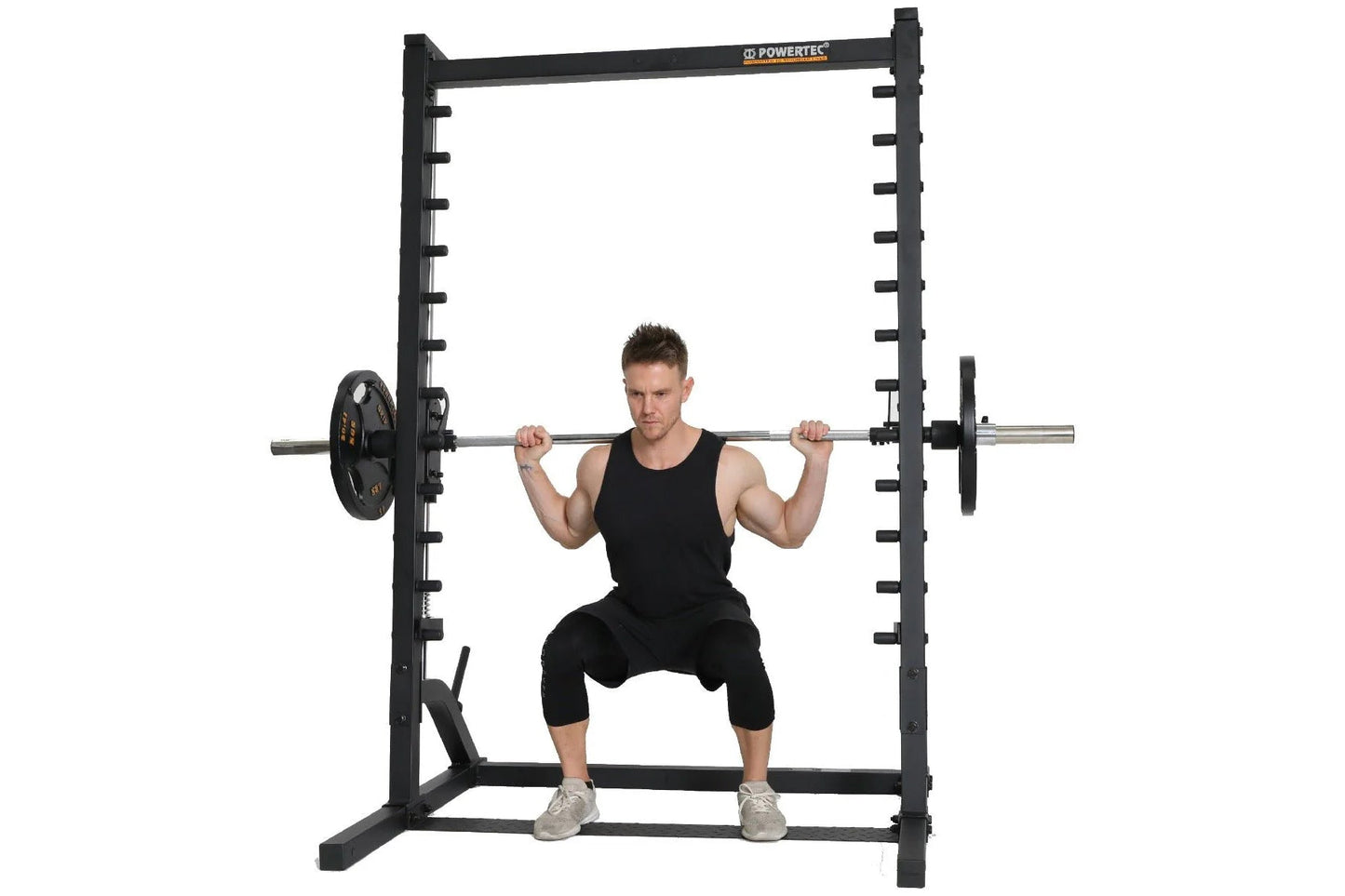Black Powertec smith machine with loaded barbell, demonstrating squat exercise with model on white background