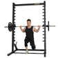 Black Powertec roller smith machine with male model performing squat exercise, chrome bar with weight plates on white backgro