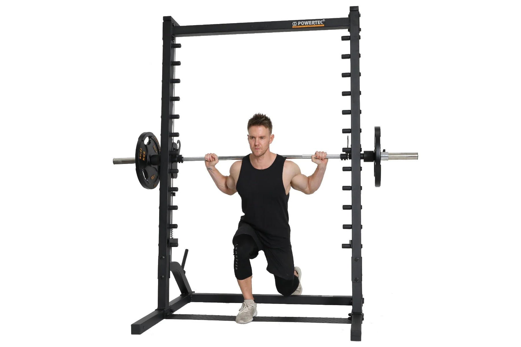 Black Powertec roller smith machine with male model performing squat exercise, chrome bar with weight plates on white backgro