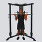 Black Powertec Streamline functional trainer with male model demonstrating shoulder press exercise on white background