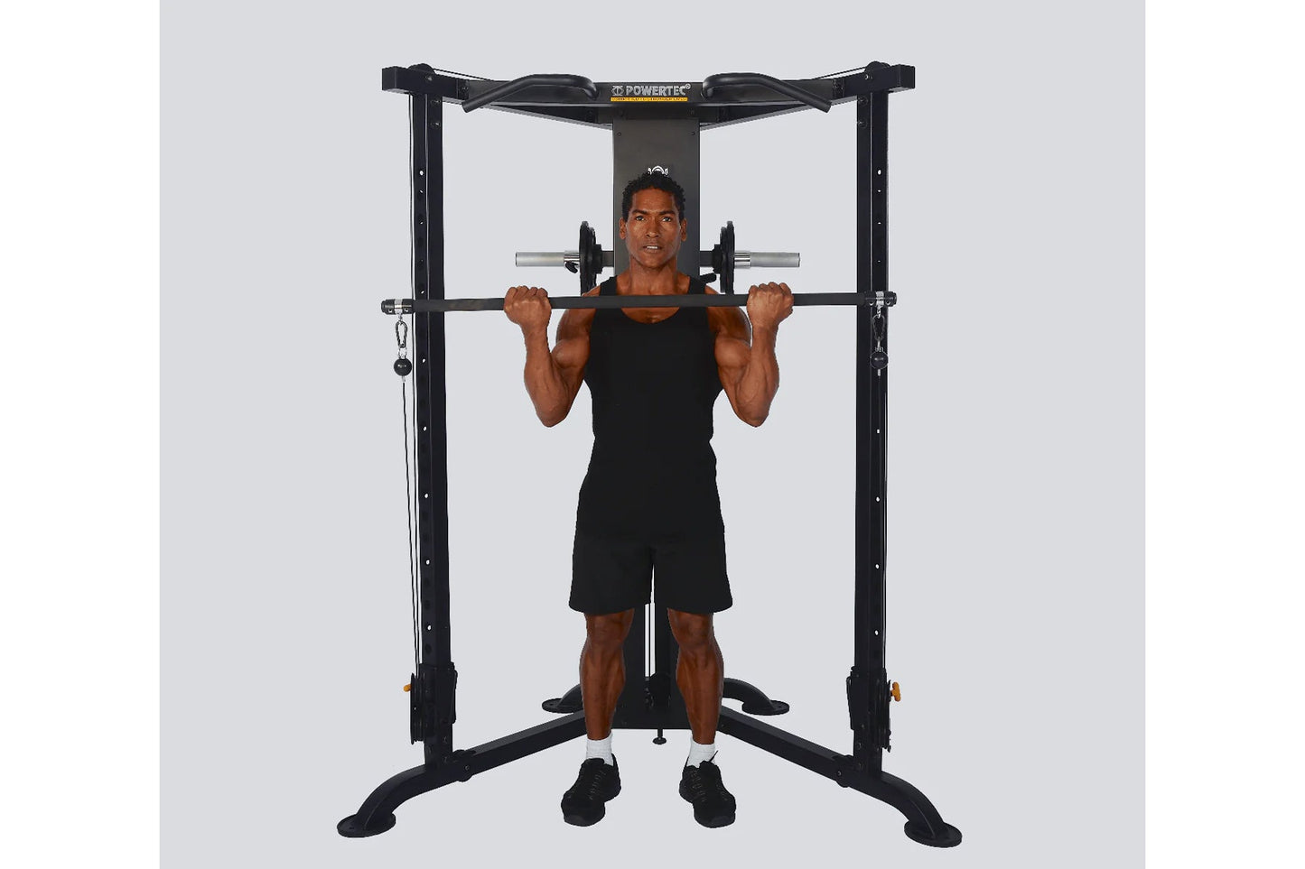 Black Powertec Streamline functional trainer with male model demonstrating shoulder press exercise on white background