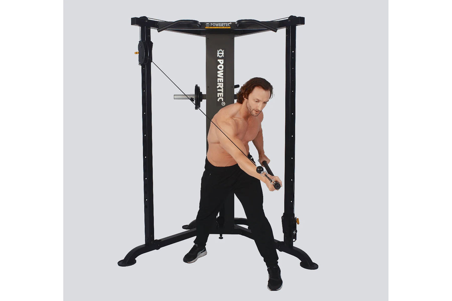Powertec Streamline Functional Trainer with black steel frame, shown in use by male model performing cable exercise