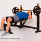 Man using black Powertec Olympic weight bench with barbell bar during chest press exercise on white background