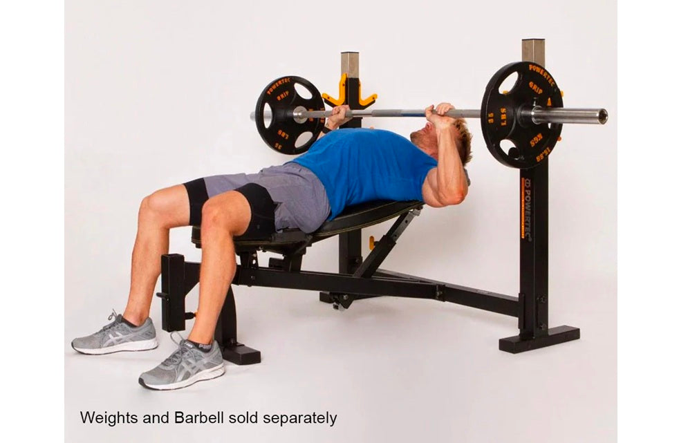 Man using black Powertec Olympic weight bench with barbell bar during chest press exercise on white background