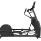 Black elliptical machine with digital console, metal frame, and foot pedals on white background
