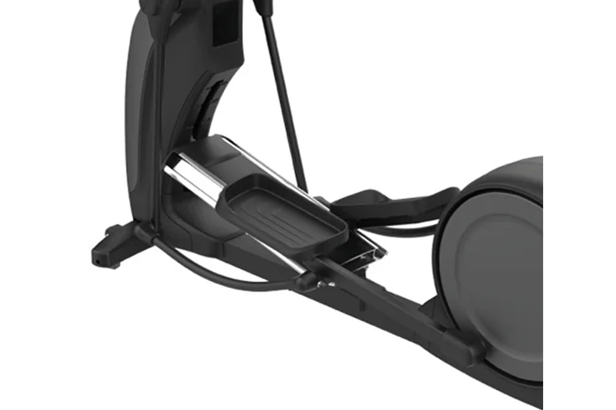 Black elliptical machine with large foot pedals, chrome accents, and attached cable on white background