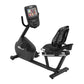 Black recumbent exercise bike with digital display console, perforated backrest, and foot pedals on white background