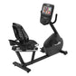 Black recumbent exercise bike with padded seat, digital touchscreen console mounted on arm, and foot pedals on white backgrou