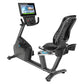 Precor RBK 800 recumbent exercise bike with black frame, blue accents, digital display console, and cushioned seat on white b