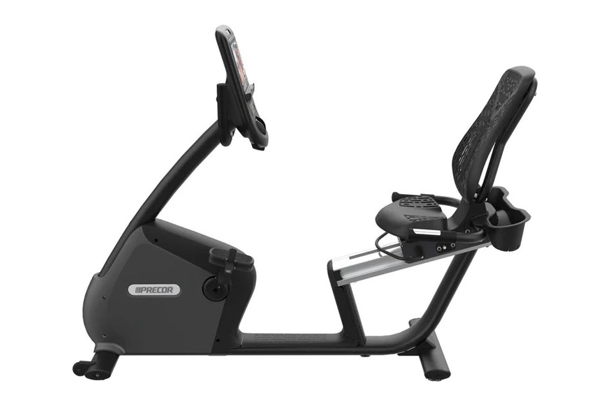 Precor RBK 865 recumbent exercise bike with black frame, padded seat and backrest, digital console, and foot pedals on white 